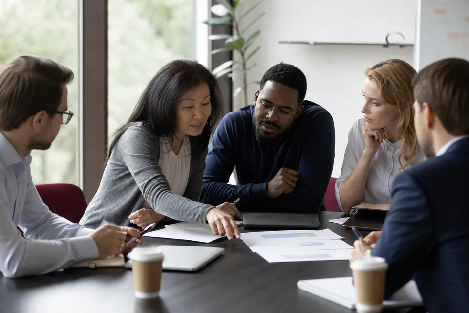 Aspiring business buyers in a workshop reviewing a deal summary together